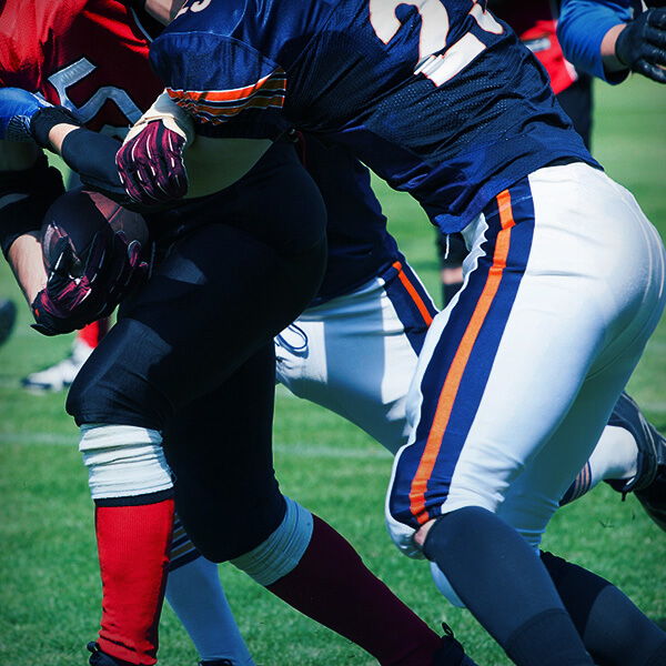 Image focused on Football players' knees