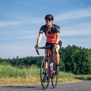 a man riding a bike wearing professional gear